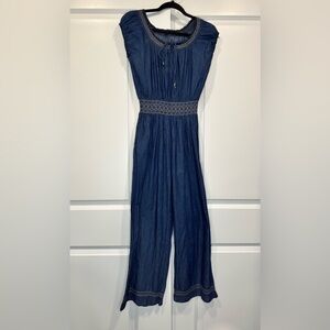 Denim jumpsuit that ties with stitching detail.